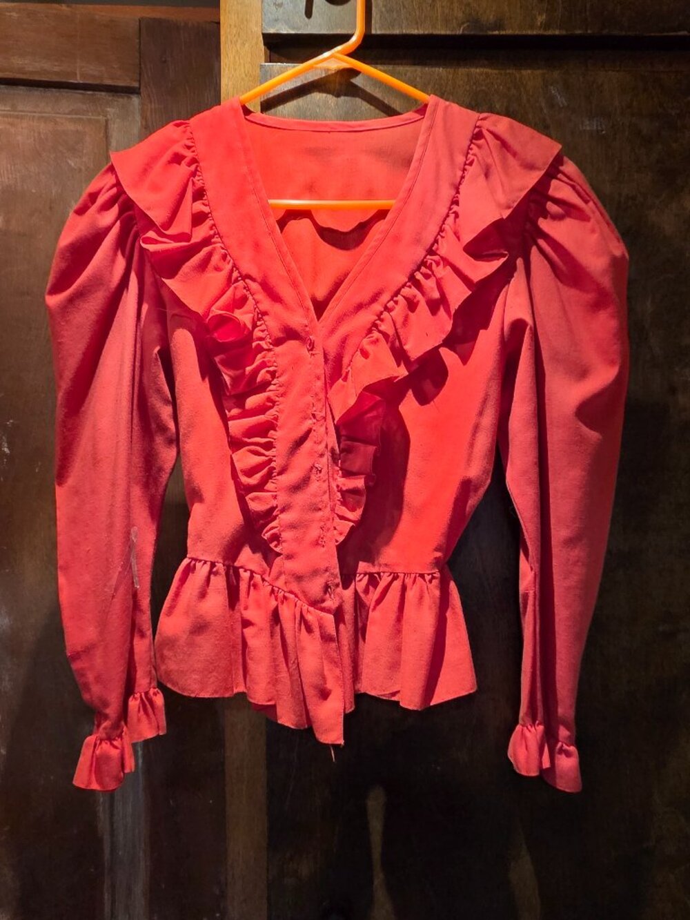 red cotton blouse, puff shoulders, long sleeves with ruffled cuffs, peplum waist